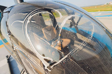 Detail of Helicopter Engineering on a beautiful blue sky,Military Helicopter fighter cockpit. Outdoor wash with sponge and foam.の写真素材