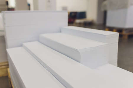 stacks of printed sheets of cardboard on wooden pallets closeup. printing industry.