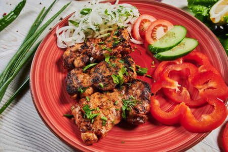 Lamb kebab on a wooden skewer . Set of Shish Kebabs . beef kebab on a wooden board . Red cabbage sauerkraut . mashed potatoes . Garlic, Onion, Tomatoes. Chopped coriander .の写真素材