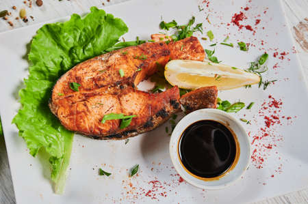 fish steak with vegetables on white background.