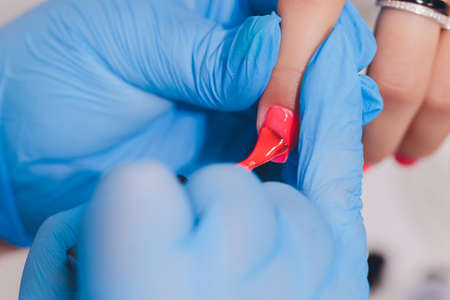 woman doing manicure in a beauty salon. Close-up of hands.の写真素材