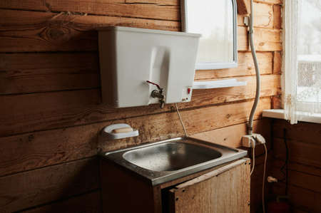 A luxurious living room, with comfortable furnishings, in a modern log cabin in the mountains.の写真素材