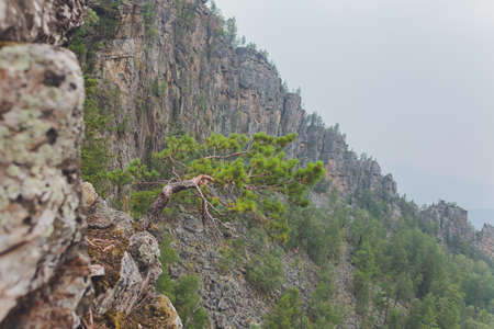 Rocks of Aigir in the smoke of a forest fire. Bashkortostan.