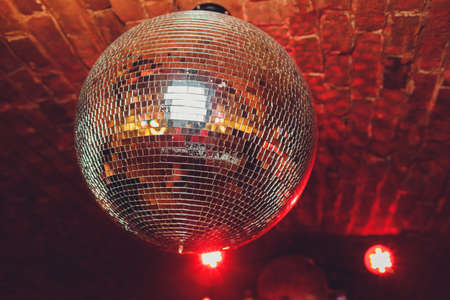 Colorful disco mirror ball lights night club background.の写真素材