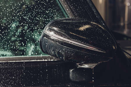 Close up of paint protection film installation on side mirror of modern luxury car. PPF is polyurethane film applied to painted of car to protect the paint from stone chips, bug splatter, and abrasionの写真素材