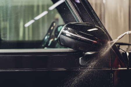 Close up of paint protection film installation on side mirror of modern luxury car. PPF is polyurethane film applied to painted of car to protect the paint from stone chips, bug splatter, and abrasionの写真素材