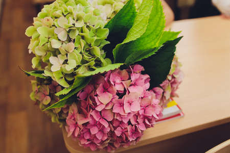 A flower bouquet with a lot of a different flowers.