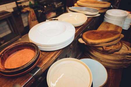 Group of white plates stacked together in a hotel and blurred background Catering buffet food dish with food on a table.の写真素材