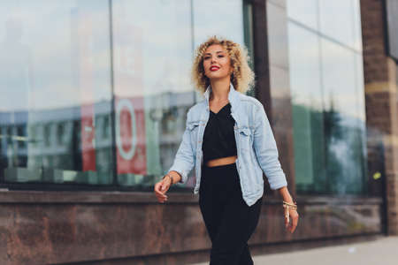 pretty young woman in casual clothes inside trade centre background.の写真素材