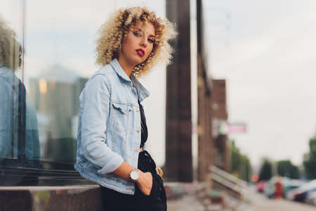 pretty young woman in casual clothes inside trade centre background.
