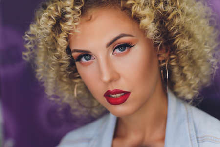 Backstage scene: Professional Make-up artist doing glamour model makeup at work.の写真素材