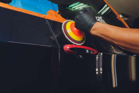 Hands with Auto polisher. Car repair service.の写真素材