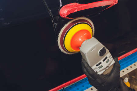 Hands with Auto polisher. Car repair service.の写真素材