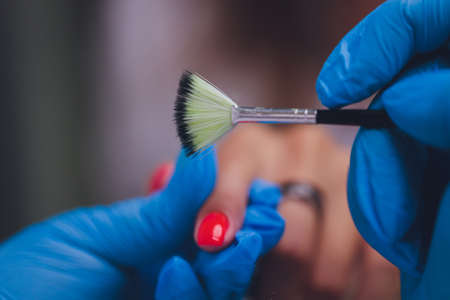 woman doing manicure in a beauty salon. Close-up of hands.