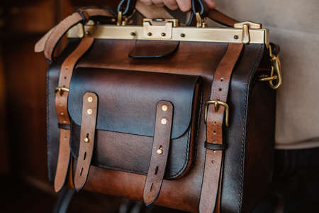 Business man holding elegant brown leather briefcase.の写真素材