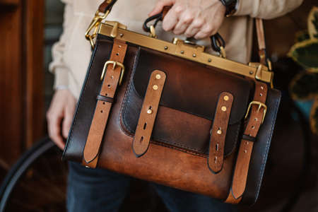 Business man holding elegant brown leather briefcase.の写真素材
