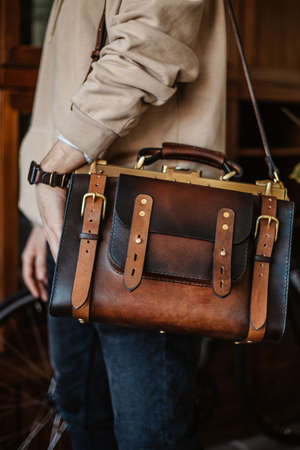 Business man holding elegant brown leather briefcase.の写真素材