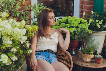 Young woman selecting flowers on flower market or in shop on a summer day.の写真素材