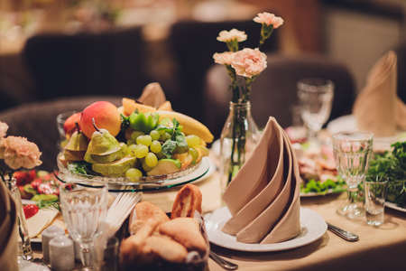 Table setting at a luxury wedding reception. Beautiful flowers on the table.の写真素材