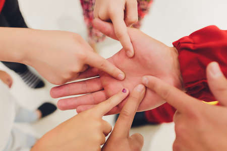 Close up of high five hand gesture, symbol of common celebration or greeting, people planning to reach their goal, slap each other to start working together. Success and teamwork concept.の写真素材