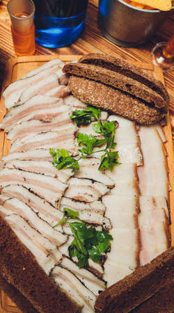 Russian appetizer for vodka. Lard and rye bread. Meat platter. Food background.の写真素材