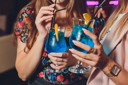 people at the festival hold alcoholic cocktails in their hands.