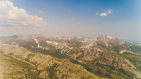 Green forest among the red mountains in the Magadan region.