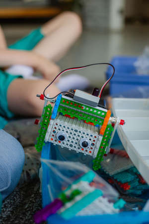 schoolboy study in a robotics class, assemble a robot constructor.