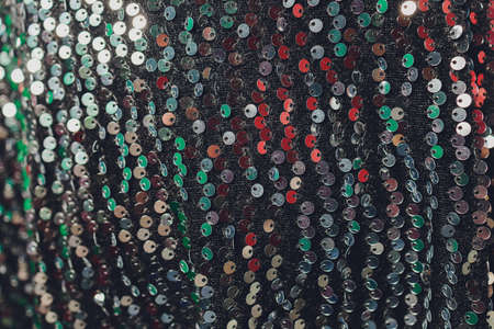 Sequins close-up macro. Abstract background with sequins colorful on the fabric.の写真素材