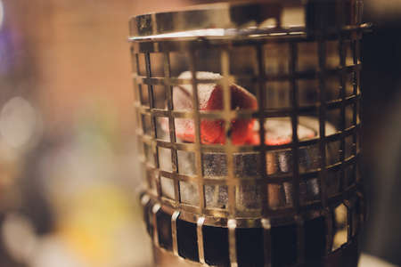 Coals for hookah close-up. Burning coals on the hookah bowl.