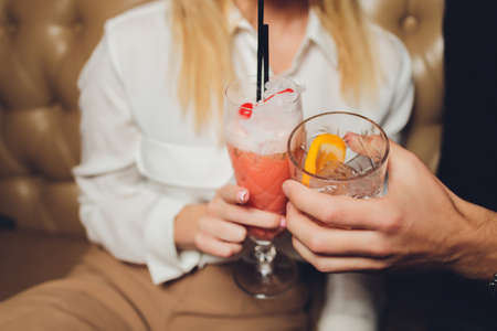 people at the festival hold alcoholic cocktails in their hands.