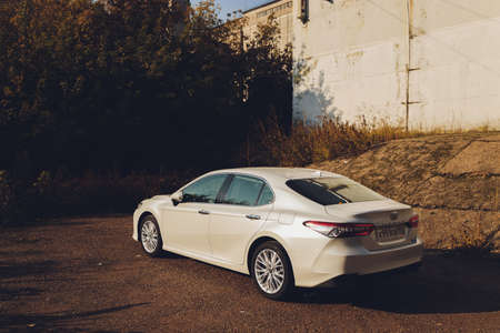Ufa, Russia, 07-10-2020: Brand new Toyota Camry hybrid model 2020. General front view during sunset.