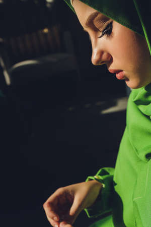 Muslim woman in hijab praying on mat indoors.の写真素材