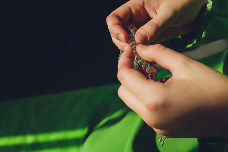 Muslim woman in hijab praying on mat indoors.の写真素材