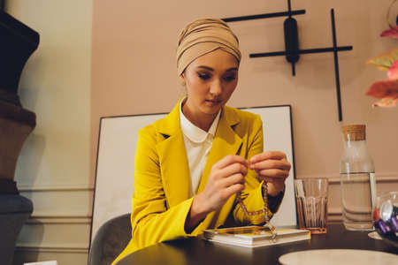 Portrait of a beautiful, elegant and attractive young Malay Asian Muslim woman in a dress and an...