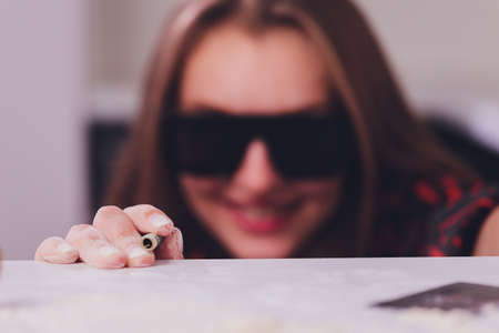 Swag girl sniffing cocaine imitation, flour . blonde Woman stoned. White background.の写真素材