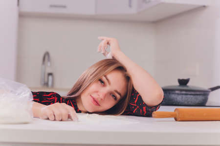 partial view of young woman in lingerie preparing dough in kitchen.の写真素材