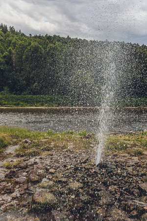 A small geyser producing bubbles and steam at the start of an eruption in the Upper Geyser Basin.の写真素材