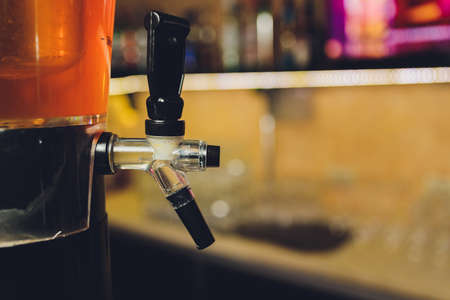 Dispenser and glasses with cold beer on table.の写真素材