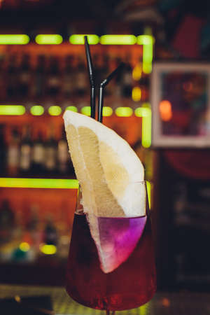 Modern Calvados Spitz Cocktail in elegant highball glass with long clear ice spear and vermouth....