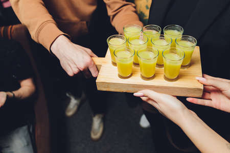 Various alcoholic shots in shot glasses in a serving tray often used for offers in the drinks...