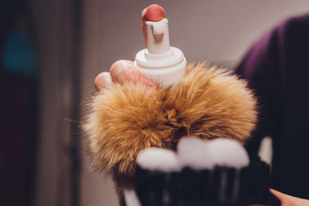 Hands cleaning mens camel suede desert shoe boot with a brush.の写真素材