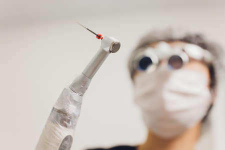 feMale dentist in special glasses with magnifying glasses and mask. Medical worker.
