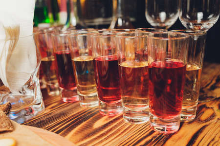Test tubes with multi-colored liquid. Alcohol in test tubes dark bar.の写真素材