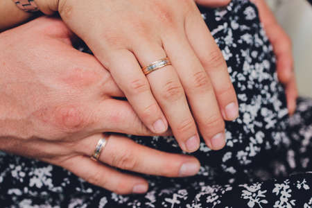 The groom holds the brides hand at the wedding ceremony. Hold hands and walk together. Confidence....