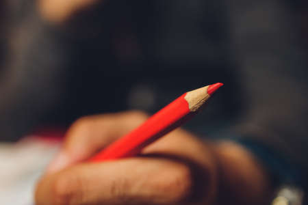 close-up. womans hand holding a red pen.の写真素材