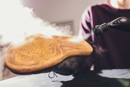 washing the dirty cleaning the shoes with a steam cleaner.の写真素材