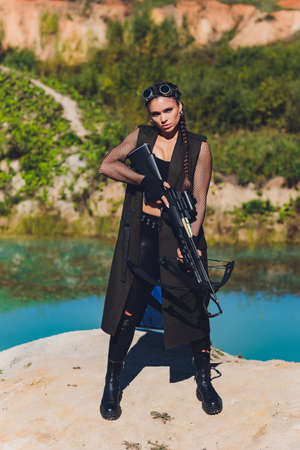 Athlete aiming Young woman holding the crossbow.