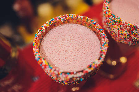 Glasses of milkshake, frappe, ice coffee and smoothie with whipped cream.