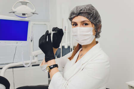 Close-up Of A Womans Hand Putting Transparent Aligner In Teeth.